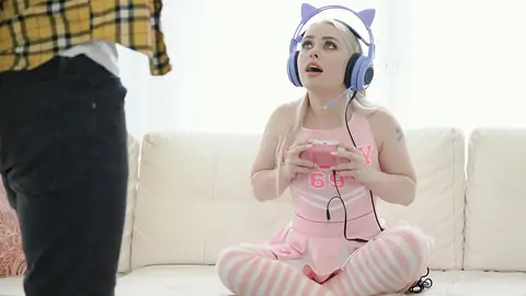 Cosplaying blond wearing headphones while gaming